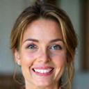 Smiling portrait of Emma R., a woman in her early 40s with bright eyes